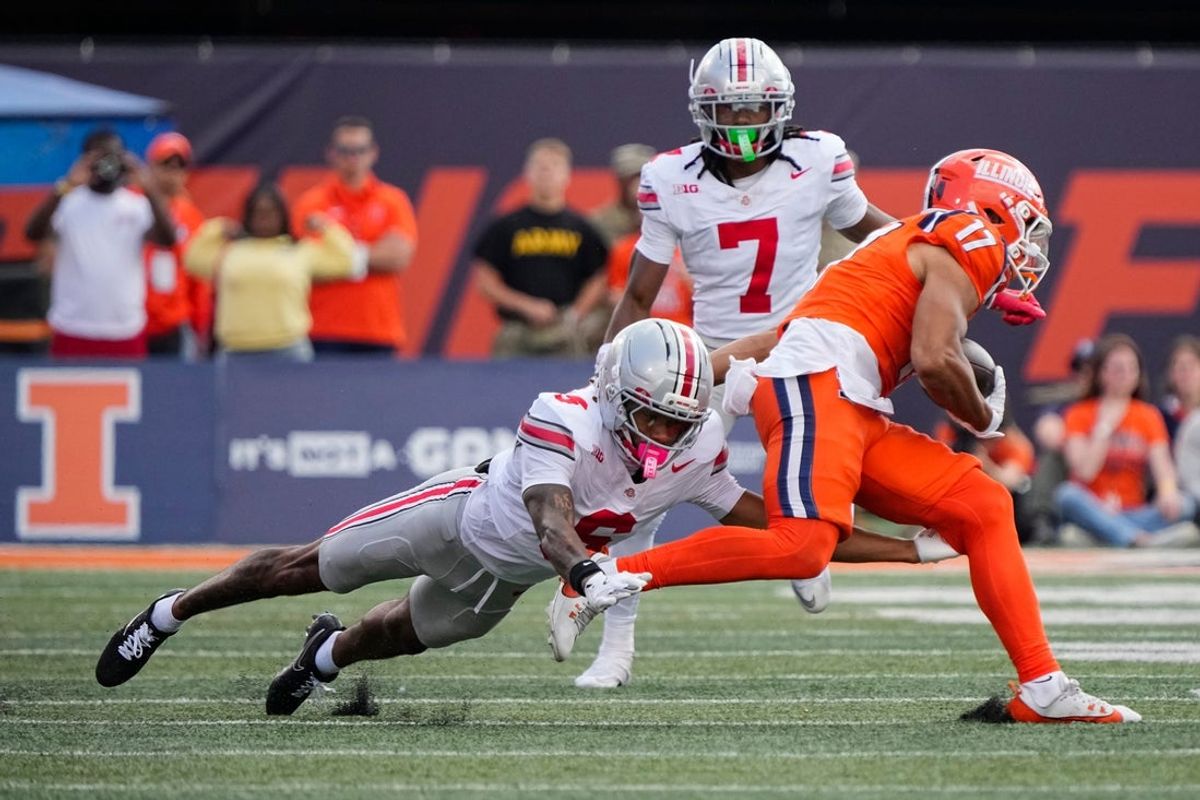 Ohio State Buckeyes cornerback Devin Sanchez (6) tackles Illinois Fighting Illini wide receiver Collin Dixon (17) during the second half of the NCAA football game at Gies Memorial Stadium in Champaign on Oct. 11, 2025. Ohio State won 34-16.
