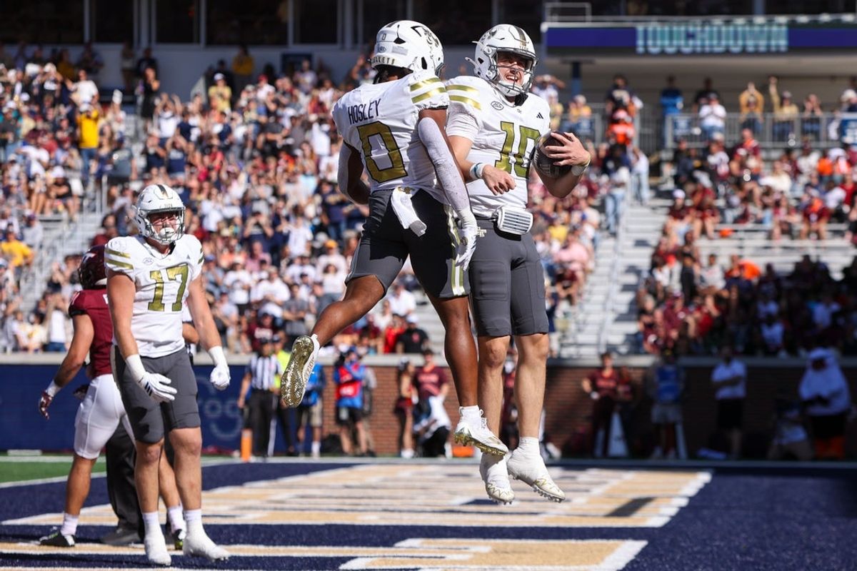 Oct 11, 2025; Atlanta, Georgia, USA; Georgia Tech Yellow Jackets quarterback Haynes King (10) celebrates with running back Malachi Hosley (0) after a touchdown against the Virginia Tech Hokies in the first quarter at Bobby Dodd Stadium at Hyundai Field. Mandatory Credit: Brett Davis-Imagn Images