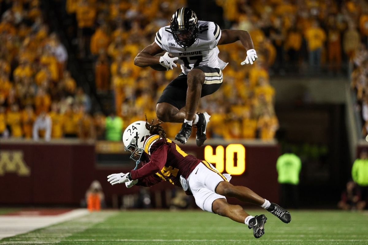 Oct 11, 2025; Minneapolis, Minnesota, USA; Purdue Boilermakers tight end Rico Walker (17) hurdles over Minnesota Golden Gophers defensive back Jai'Onte' McMillan (24) during the first half at Huntington Bank Stadium. Mandatory Credit: Matt Krohn-Imagn Images