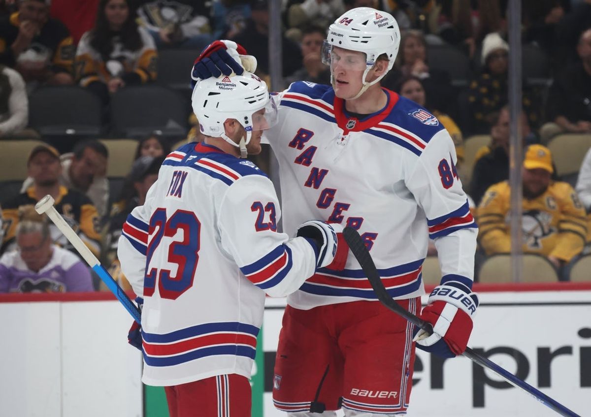 Oct 11, 2025; Pittsburgh, Pennsylvania, USA;  New York Rangers center Adam Edstrom (84) congratulates defenseman Adam Fox (23) on his goal against the Pittsburgh Penguins during the second period at PPG Paints Arena. Mandatory Credit: Charles LeClaire-Imagn Images