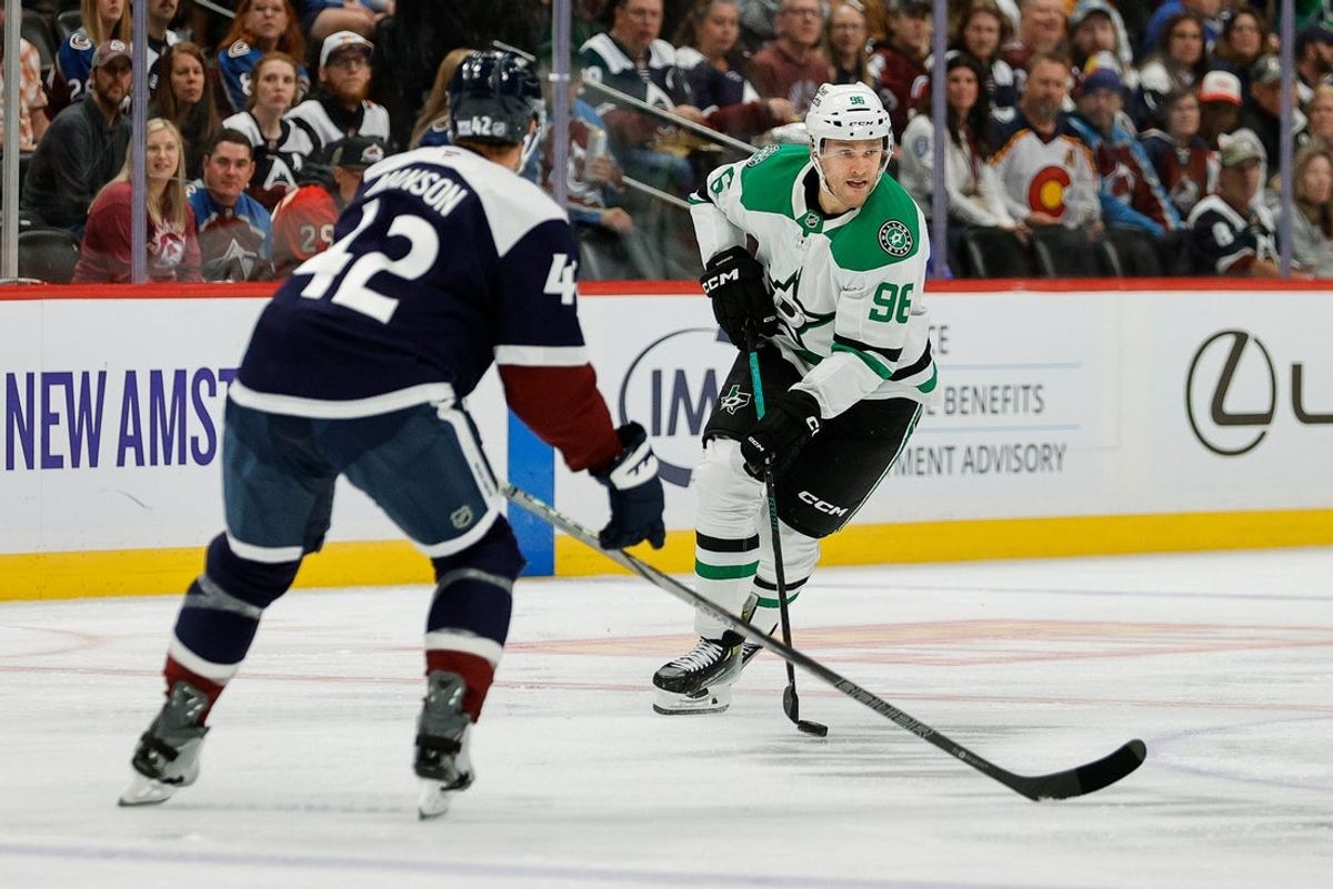 Oct 11, 2025; Denver, Colorado, USA; Dallas Stars right wing Mikko Rantanen (96) controls the puck as Colorado Avalanche defenseman Josh Manson (42) defends in the first period at Ball Arena. Mandatory Credit: Isaiah J. Downing-Imagn Images