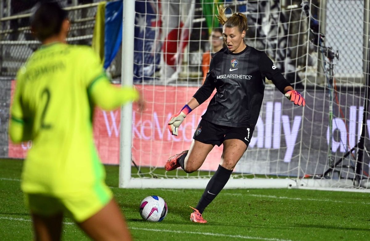 Oct 11, 2025; Cary, North Carolina, USA; North Carolina Courage goalkeeper Casey Murphy (1) clears the ball in front of Washington Spirit forward Trinity Rodman (2) during the first half at First Horizon Stadium at WakeMed Soccer Park. Mandatory Credit: Rob Kinnan-Imagn Images