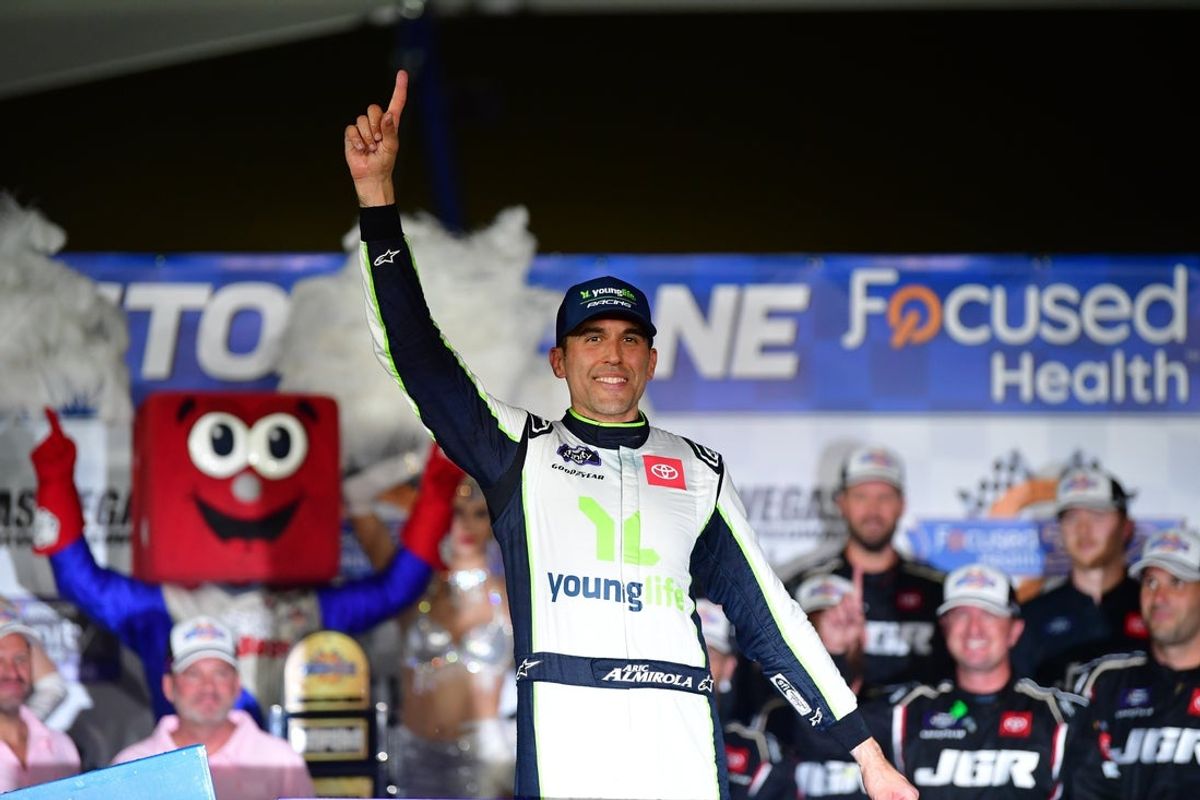 Oct 11, 2025; Las Vegas, Nevada, USA; NASCAR Xfinity Series driver Aric Almirola (19) celebrates his victory following the Focused Health 302 at Las Vegas Motor Speedway. Mandatory Credit: Gary A. Vasquez-Imagn Images