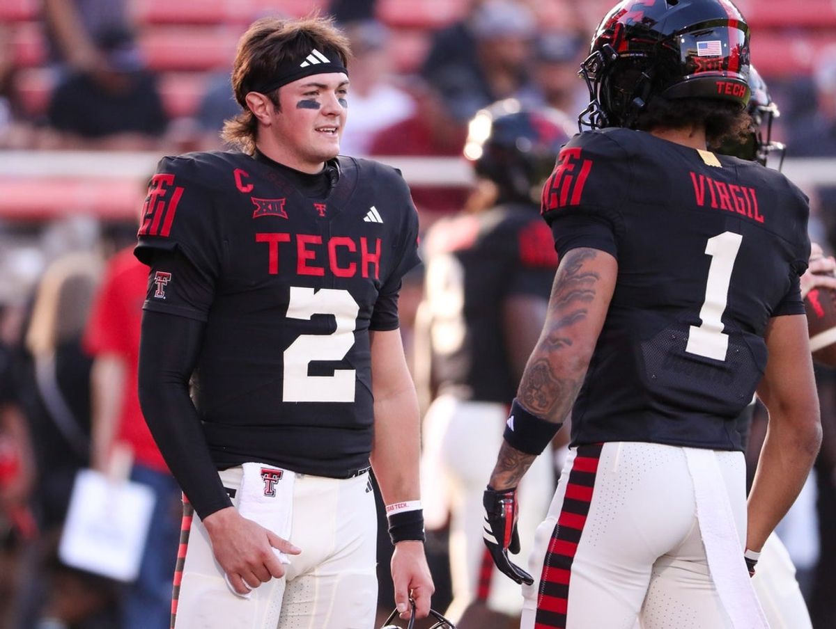 Texas Tech's Behren Morton talks to Reggie Virgil prior to a Big 12 Conference football game, Saturday, Oct. 11, 2025, at Jones AT&T Stadium in Lubbock.
