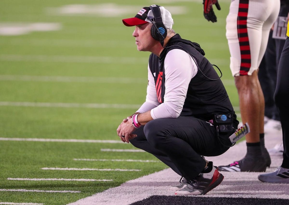 Texas Tech head coach Joey McGuire crouches on the sideline during a Big 12 Conference football game, Saturday, Oct. 11, 2025, at Jones AT&T Stadium in Lubbock.