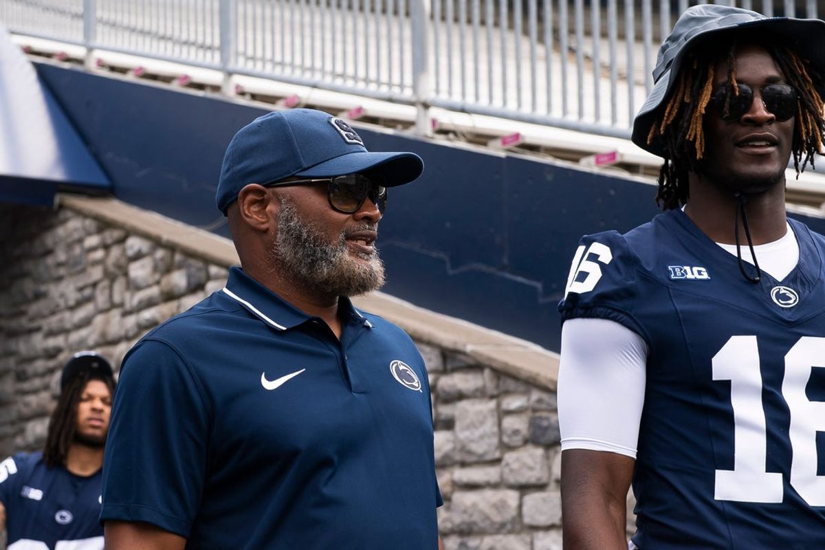 Penn State cornerbacks coach Terry Smith talks with CB Elliot Washington II (16) during football media day at Beaver Stadium on Sunday, August 6, 2023, in State College.