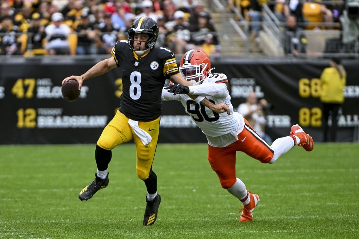 Oct 12, 2025; Pittsburgh, Pennsylvania, USA; Pittsburgh Steelers quarterback Aaron Rodgers (8) attempts to run the ball while Cleveland Browns defensive end Joe Tryon-Shoyinka (90) pursues during the second quarter at Acrisure Stadium. Mandatory Credit: Barry Reeger-Imagn Images