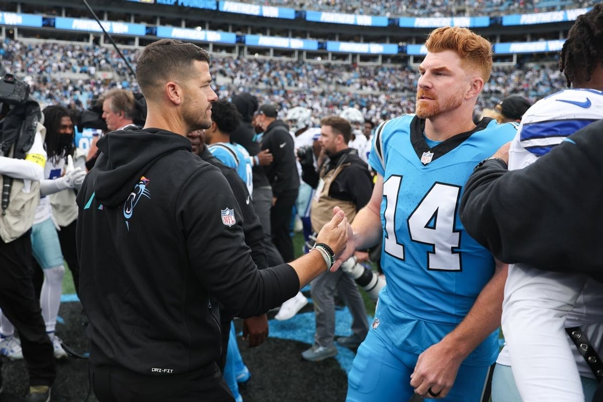 Oct 12, 2025; Charlotte, North Carolina, USA; Carolina Panthers head coach Dave Canales shakes hands with Carolina Panthers quarterback Andy Dalton (14) after the game against the Dallas Cowboys at Bank of America Stadium. Mandatory Credit: Cory Knowlton-Imagn Images