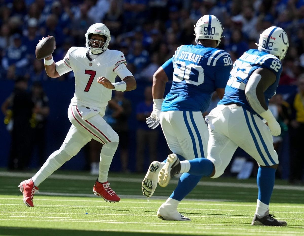 Arizona Cardinals quarterback Jacoby Brissett (7) looks to throw while Indianapolis Colts defensive tackle Grover Stewart (90) and defensive tackle Neville Gallimore (92) attempt to bring him down during a game on Sunday, Oct. 12, 2025, at Lucas Oil Stadium in Indianapolis. The Colts defeated the Cardinals 31-27.
