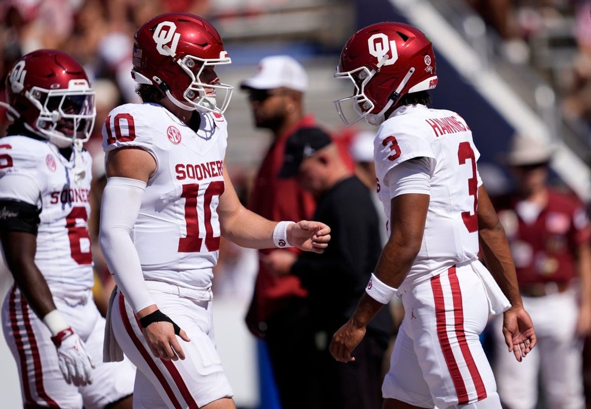 Oklahoma Sooners quarterback John Mateer (10) and Oklahoma Sooners quarterback Michael Hawkins Jr. (3) warm up before the Red River Rivalry college football game between the University of Oklahoma Sooners and the Texas Longhorn at the Cotton Bowl Stadium in Dallas, Texas, Saturday, Oct. 11, 2025.