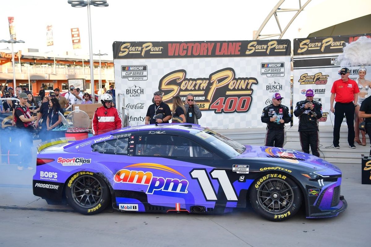 Oct 12, 2025; Las Vegas, Nevada, USA; NASCAR Cup Series driver Denny Hamlin (11) arrives in victory lane following his victory of the South Point 400 at Las Vegas Motor Speedway. Mandatory Credit: Gary A. Vasquez-Imagn Images