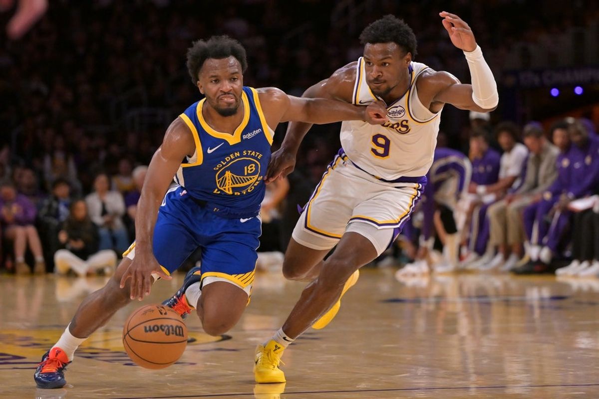 Oct 12, 2025; Los Angeles, California, USA;  Golden State Warriors guard LJ Cryer (18) is defended by Los Angeles Lakers guard Bronny James (9) as he drives to the basket during the second half at Crypto.com Arena. Mandatory Credit: Jayne Kamin-Oncea-Imagn Images