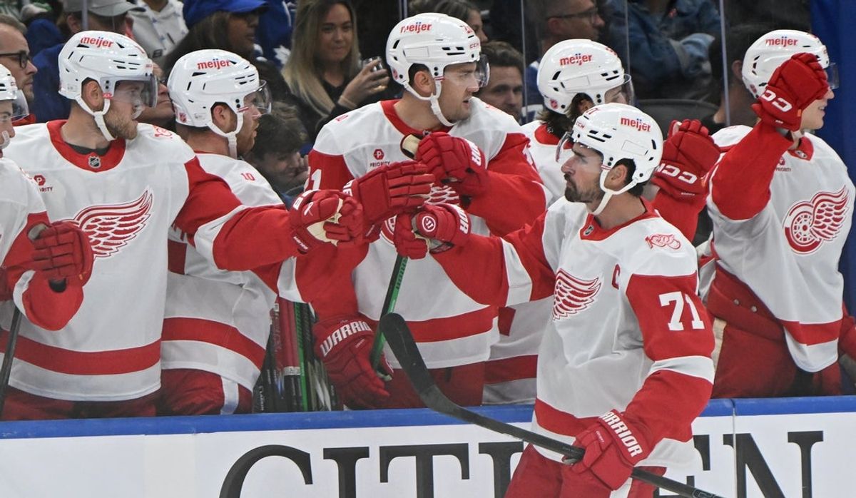 Oct 13, 2025; Toronto, Ontario, CAN; Detroit Red Wings center Dylan Larkin (71) celebrates a goal at the bench in the first period against the Toronto Maple Leafs at Scotiabank Arena. Mandatory Credit: Gerry Angus-Imagn Images