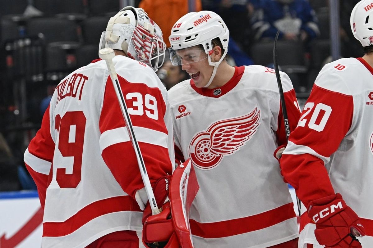 Oct 13, 2025; Toronto, Ontario, CAN; Detroit Red Wings right wing Michael Brandsegg Nygard (28) celebrates the victory over the Toronto Maple Leafs with goalie Cameron Talbot (39) at Scotiabank Arena. Mandatory Credit: Gerry Angus-Imagn Images