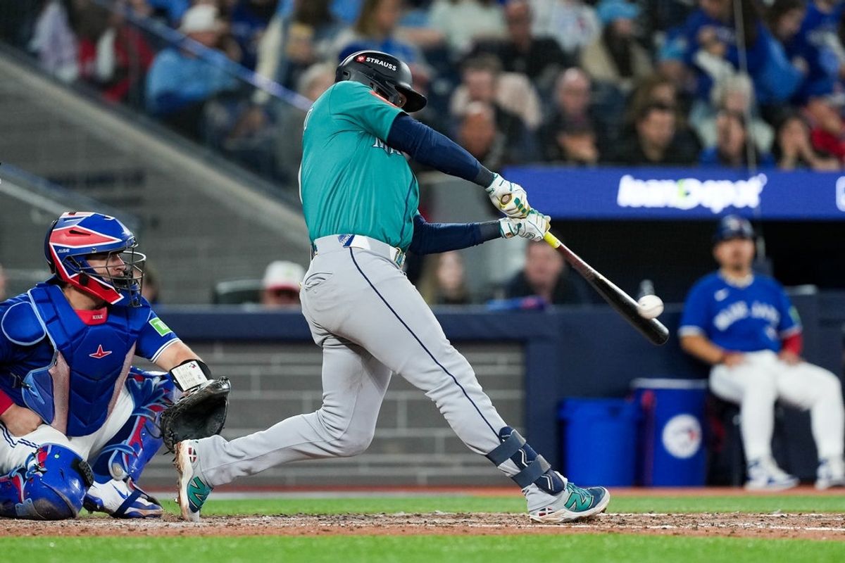 Oct 13, 2025; Toronto, Ontario, CAN; Seattle Mariners infielder Jorge Polanco (7) singles in the seventh inning against the Toronto Blue Jays during game two of the ALCS round for the 2025 MLB playoffs at Rogers Centre. Mandatory Credit: Nick Turchiaro-Imagn Images
