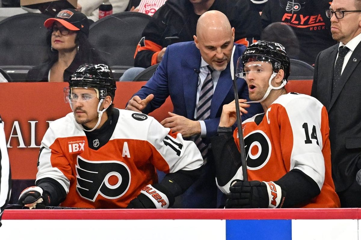 Oct 13, 2025; Philadelphia, Pennsylvania, USA; Philadelphia Flyers head coach Rick Tocchet talks with Philadelphia Flyers center Sean Couturier (14) and right wing Travis Konecny (11) against the Florida Panthers during the first period at Wells Fargo Center. Mandatory Credit: Eric Hartline-Imagn Images