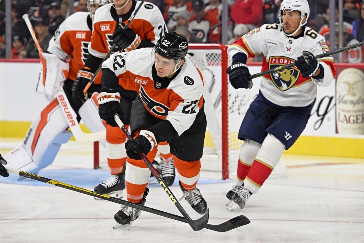 Oct 13, 2025; Philadelphia, Pennsylvania, USA; Philadelphia Flyers center Christian Dvorak (22) clears the puck against the Florida Panthers during the first period at Wells Fargo Center. Mandatory Credit: Eric Hartline-Imagn Images