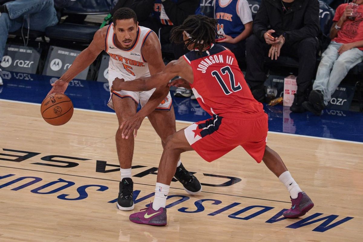 Oct 13, 2025; New York, New York, USA; New York Knicks guard Malcolm Brogdon (5) dribbles against Washington Wizards guard Tre Johnson (12) during the first quarter at Madison Square Garden. Mandatory Credit: Vincent Carchietta-Imagn Images