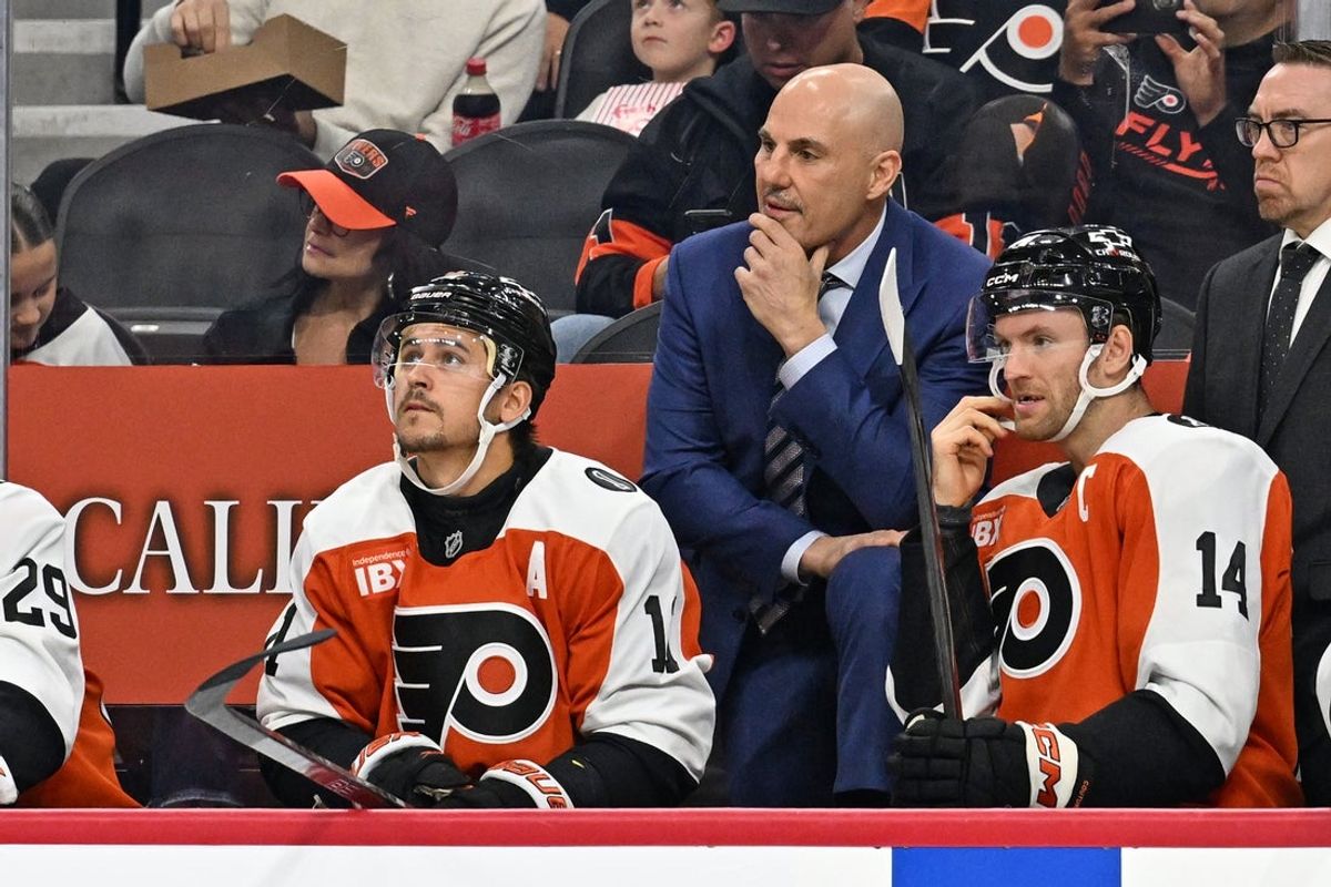 Oct 13, 2025; Philadelphia, Pennsylvania, USA; Philadelphia Flyers head coach Rick Tocchet with right wing Travis Konecny (11) and center Sean Couturier (14) against the Florida Panthers during the first period at Wells Fargo Center. Mandatory Credit: Eric Hartline-Imagn Images