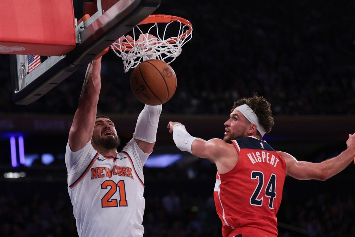 Oct 13, 2025; New York, New York, USA; New York Knicks center Alex Len (21) dunks the ball during the first half in front of Washington Wizards forward Corey Kispert (24) at Madison Square Garden. Mandatory Credit: Vincent Carchietta-Imagn Images