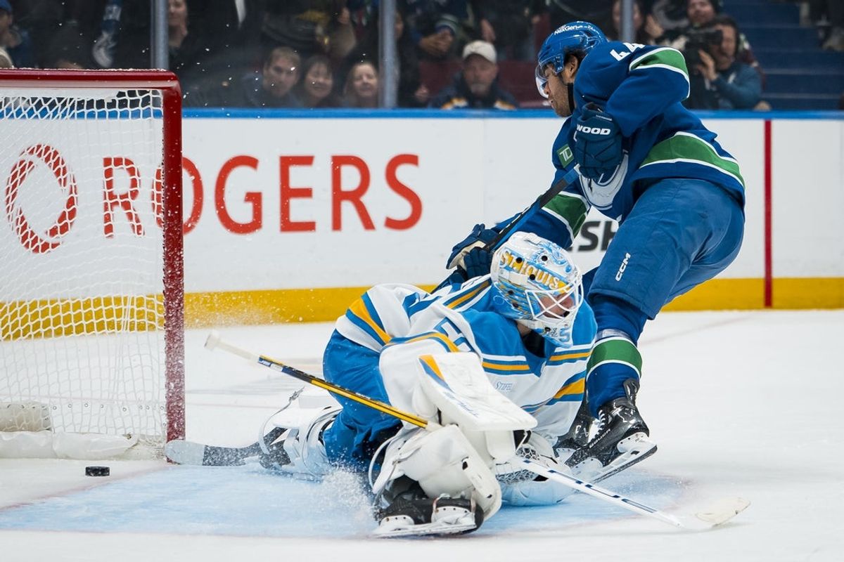 Oct 13, 2025; Vancouver, British Columbia, CAN; Vancouver Canucks forward Kiefer Sherwood (44) scores his second goal of the game on St. Louis Blues goalie Jordan Binnington (50) in the second period at Rogers Arena. Mandatory Credit: Bob Frid-Imagn Images