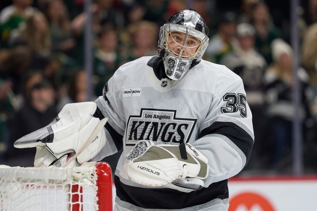 Oct 13, 2025; Saint Paul, Minnesota, USA; Los Angeles Kings goaltender Darcy Kuemper (35) has to replace his mask in overtime against the Minnesota Wild at Grand Casino Arena. Mandatory Credit: Matt Blewett-Imagn Images