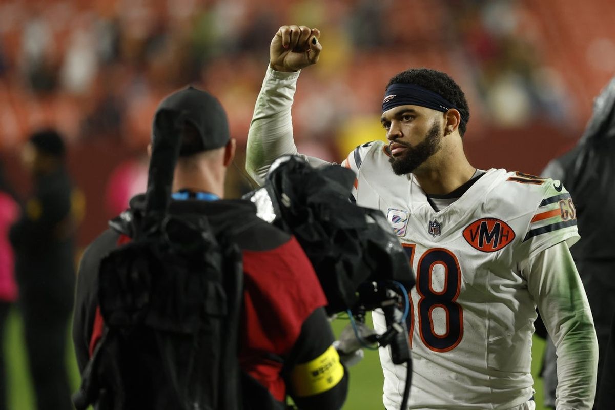 Oct 13, 2025; Landover, Maryland, USA; Chicago Bears quarterback Caleb Williams (18) celebrates while leaving the field after the game against the Washington Commanders at Northwest Stadium. Mandatory Credit: Geoff Burke-Imagn Images