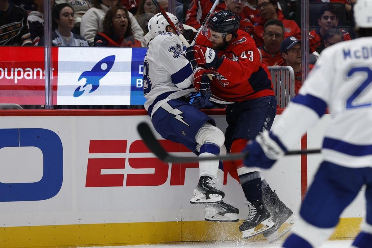Oct 14, 2025; Washington, District of Columbia, USA; Washington Capitals right wing Tom Wilson (43) checks Tampa Bay Lightning left wing Brandon Hagel (38) in the first period at Capital One Arena. Mandatory Credit: Geoff Burke-Imagn Images