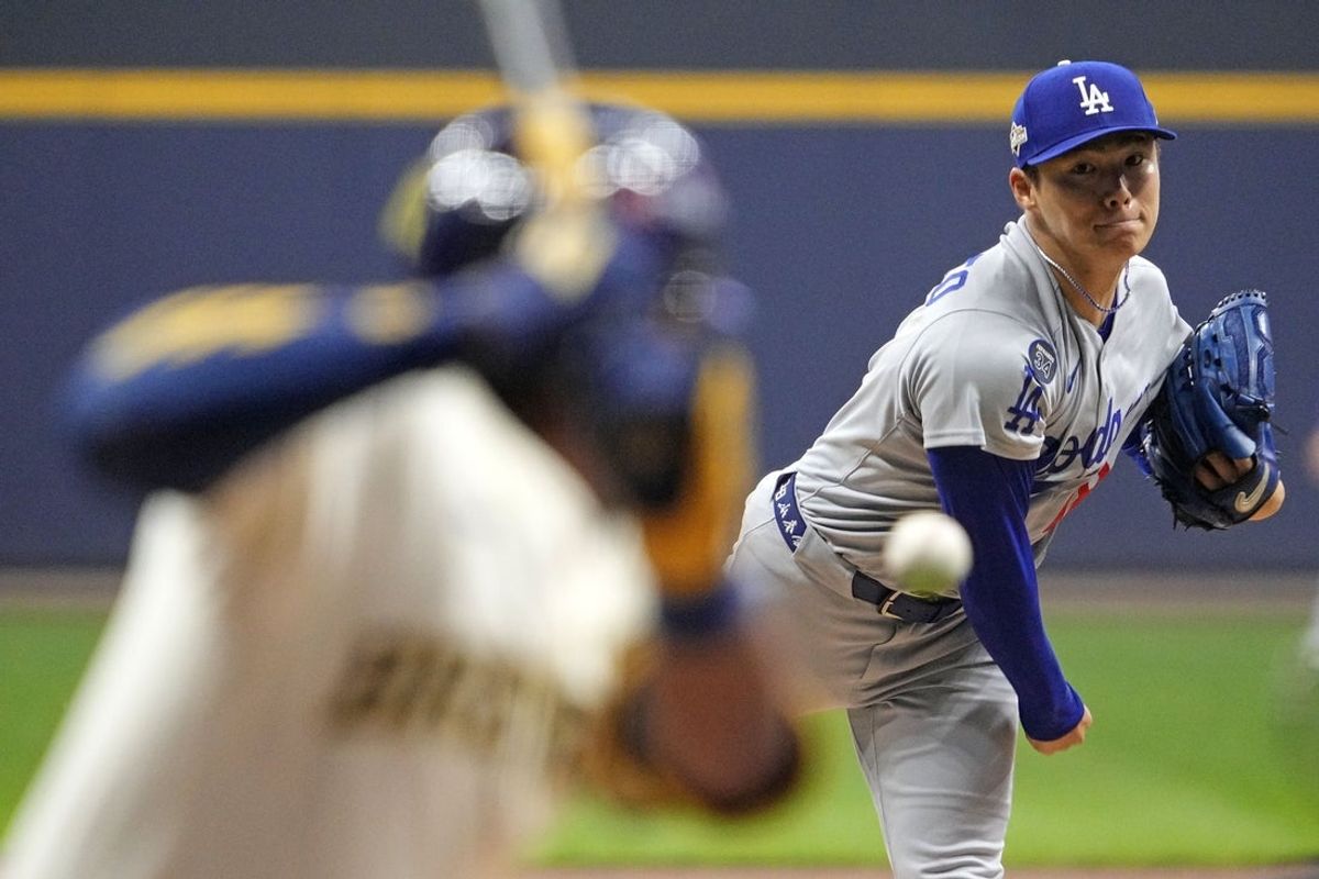 Oct 14, 2025; Milwaukee, Wisconsin, USA; Los Angeles Dodgers pitcher Yoshinobu Yamamoto (18) throws pitch against the Milwaukee Brewers in the first inning during game two of the NLCS round for the 2025 MLB playoffs at American Family Field. Mandatory Credit: Michael McLoone-Imagn Images