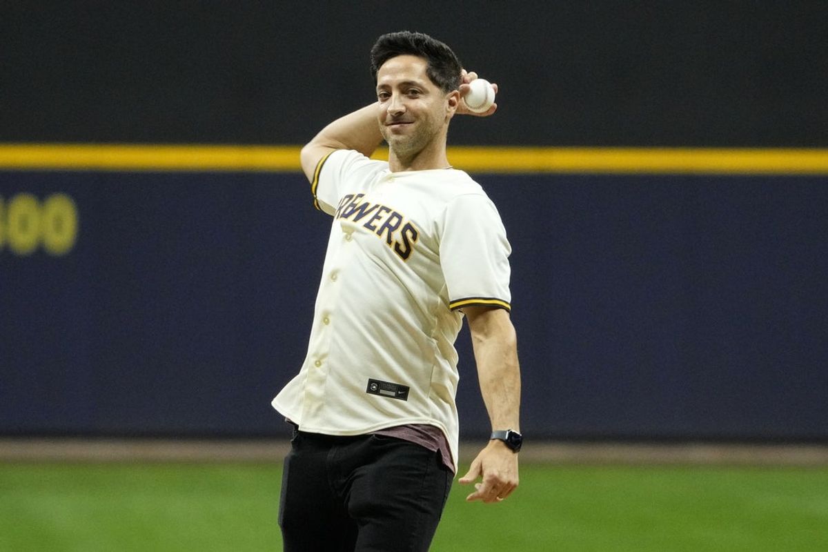 Oct 14, 2025; Milwaukee, Wisconsin, USA;  Former Milwaukee Brewers player Ryan Braun throws out the ceremonial first pitch prior to game two of the NLCS round for the 2025 MLB playoffs at American Family Field. Mandatory Credit: Michael McLoone-Imagn Images