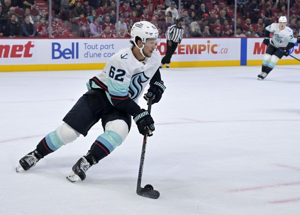 Oct 14, 2025; Montreal, Quebec, CAN; Seattle Kraken defenseman Brandon Montour (62) plays the puck against the Montreal Canadiens during the second period at the Bell Centre. Mandatory Credit: Eric Bolte-Imagn Images