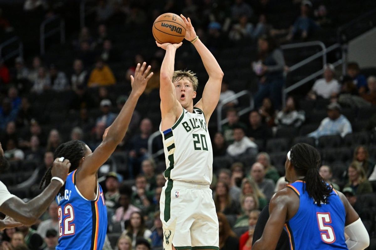 Oct 14, 2025; Milwaukee, Wisconsin, USA; Milwaukee Bucks guard A.J. Green (20) hits a three point shot against the Oklahoma City Thunder during the first half at Fiserv Forum. Mandatory Credit: Patrick Gorski-Imagn Images