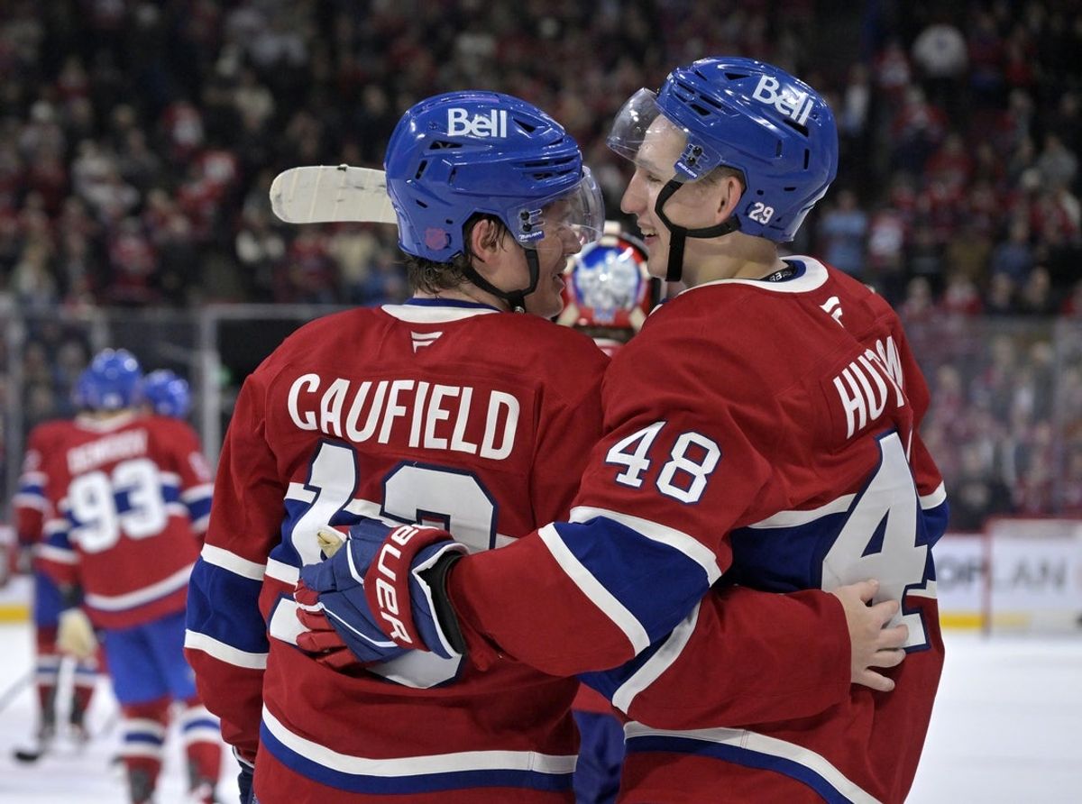Oct 14, 2025; Montreal, Quebec, CAN; Montreal Canadiens forward Cole Caufield (13) celebrates with teammate defenseman Lane Hutson (48) after scoring the winning goal against the Seattle Kraken during the overtime period at the Bell Centre. Mandatory Credit: Eric Bolte-Imagn Images
