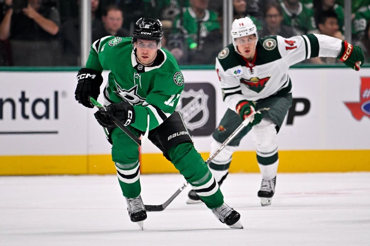Oct 14, 2025; Dallas, Texas, USA; Dallas Stars center Radek Faksa (12) chases the puck during the second period against the Minnesota Wild at the American Airlines Center. Mandatory Credit: Jerome Miron-Imagn Images