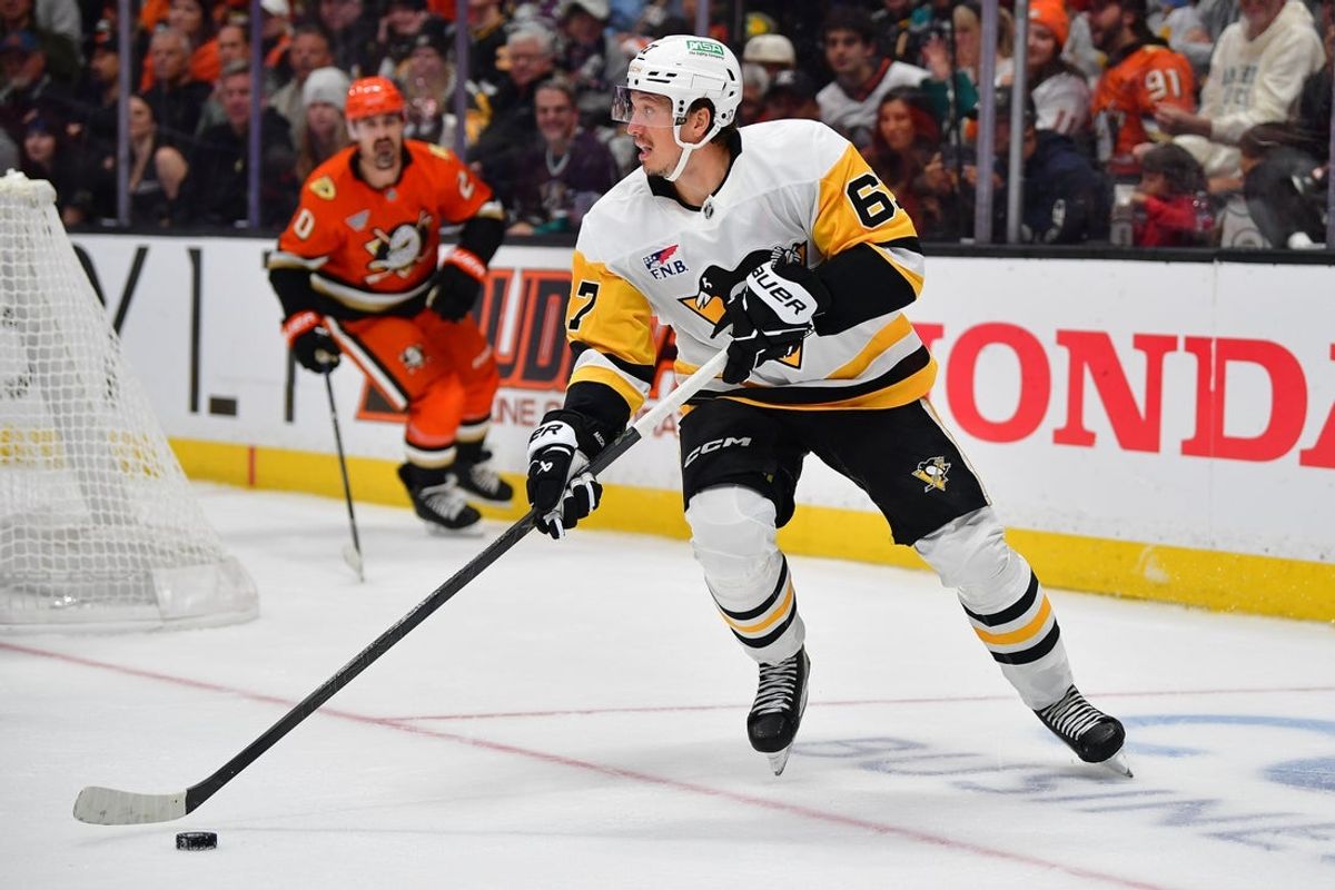 Oct 14, 2025; Anaheim, California, USA; Pittsburgh Penguins right wing Rickard Rakell (67) controls the puck against the Anaheim Ducks during the second period at Honda Center. Mandatory Credit: Gary A. Vasquez-Imagn Images
