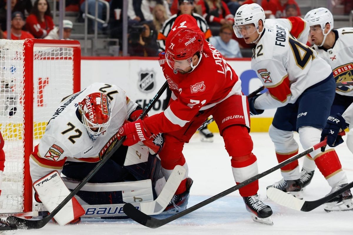 Oct 15, 2025; Detroit, Michigan, USA;  Florida Panthers goaltender Sergei Bobrovsky (72) makes the save on Detroit Red Wings center Dylan Larkin (71) in the second period at Little Caesars Arena. Mandatory Credit: Rick Osentoski-Imagn Images