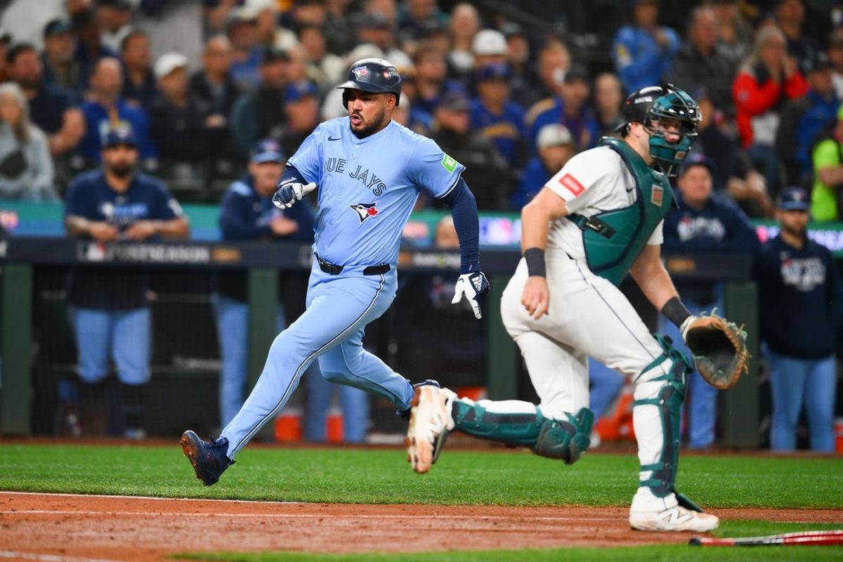 Oct 15, 2025; Seattle, Washington, USA; Toronto Blue Jays right fielder Anthony Santander (25) scores on a single from Toronto Blue Jays second baseman Ernie Clement (22) (not pictured) during the fifth inning against the Seattle Mariners during game three of the ALCS round for the 2025 MLB playoffs at T-Mobile Park. Mandatory Credit: Steven Bisig-Imagn Images
