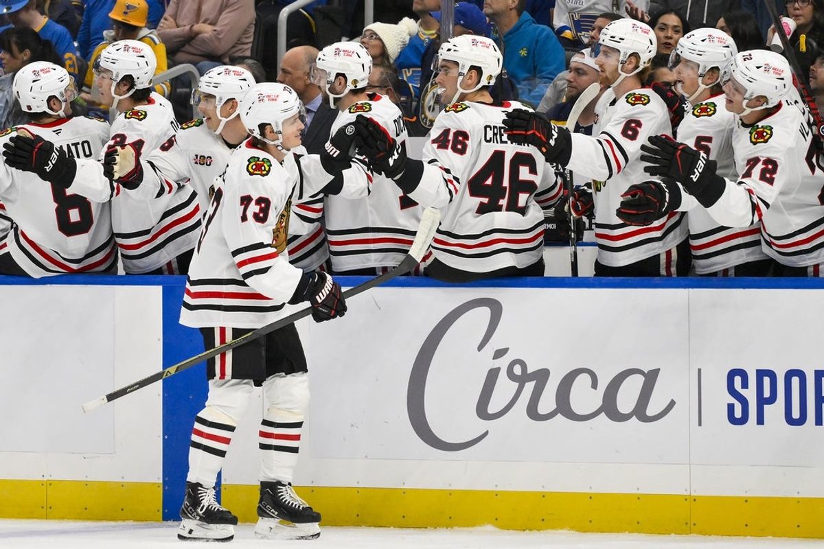 Oct 15, 2025; St. Louis, Missouri, USA; Chicago Blackhawks left wing Lukas Reichel (73) is congratulated by teammates after scoring against the St. Louis Blues during the first period at Enterprise Center. Mandatory Credit: Jeff Curry-Imagn Images