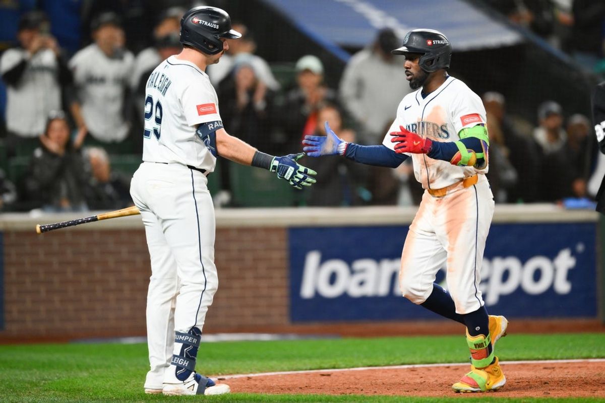 Oct 15, 2025; Seattle, Washington, USA; Seattle Mariners left fielder Randy Arozarena (56) celebrates with Seattle Mariners catcher Cal Raleigh (29) after hitting a solo home run during the eighth inning against the Toronto Blue Jays during game three of the ALCS round for the 2025 MLB playoffs at T-Mobile Park. Mandatory Credit: Steven Bisig-Imagn Images