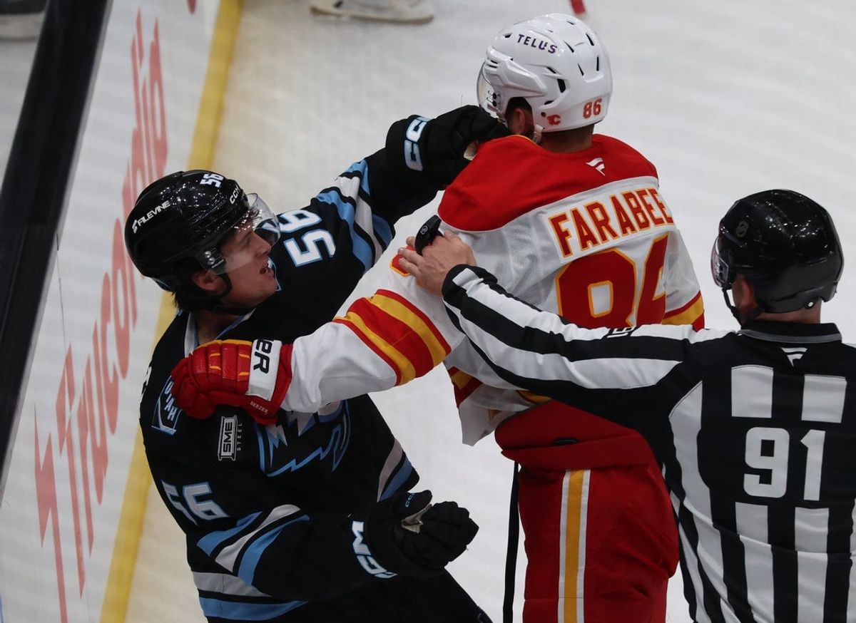 Oct 15, 2025; Salt Lake City, Utah, USA; Utah Mammoth right wing Kailer Yamamoto (56) and Calgary Flames left wing Joel Farabee (86) fight during the second period at Delta Center. Mandatory Credit: Rob Gray-Imagn Images