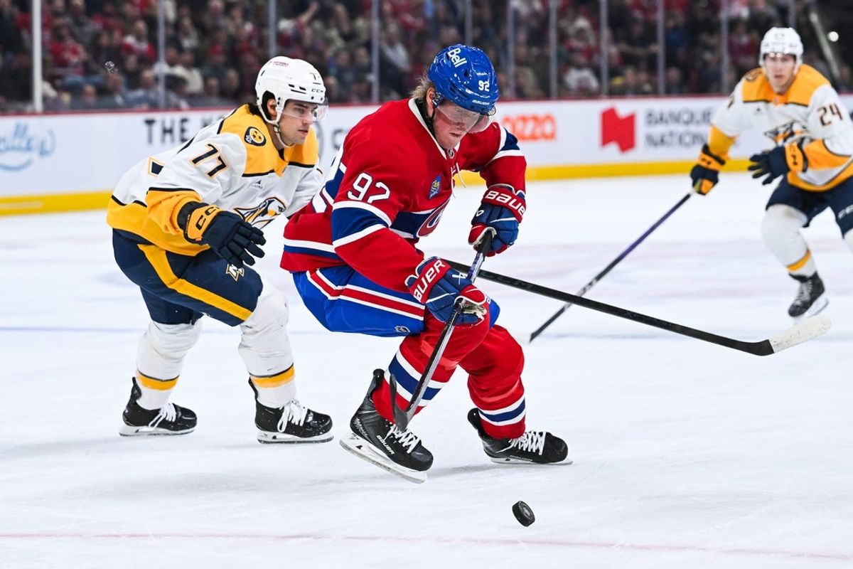 Oct 16, 2025; Montreal, Quebec, CAN; Montreal Canadiens right wing Patrik Laine (92) defends the puck against Nashville Predators right wing Luke Evangelista (77) during the first period at Bell Centre. Mandatory Credit: David Kirouac-Imagn Images