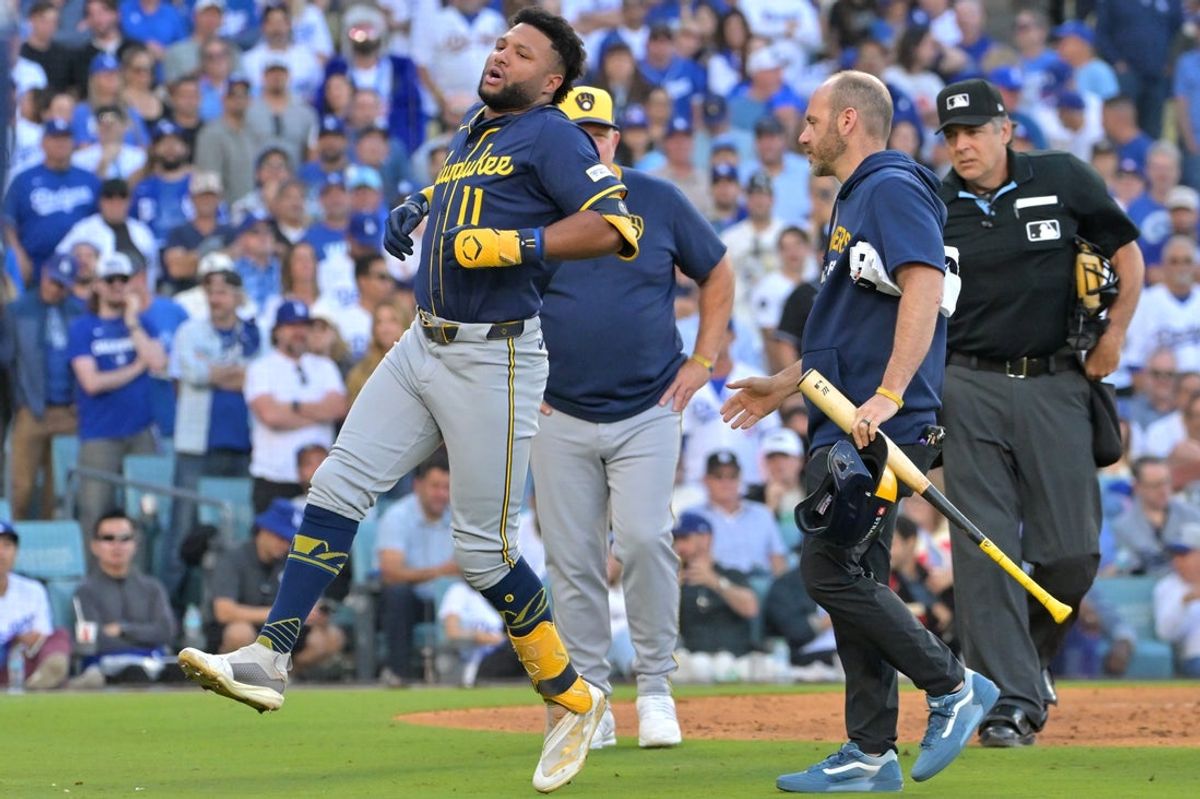 Oct 16, 2025; Los Angeles, California, USA; Milwaukee Brewers center fielder Jackson Chourio (11) reacts after an apparent injury in the seventh inning against the Los Angeles Dodgers during game three of the NLCS round for the 2025 MLB playoffs at Dodger Stadium. Mandatory Credit: Jayne Kamin-Oncea-Imagn Images