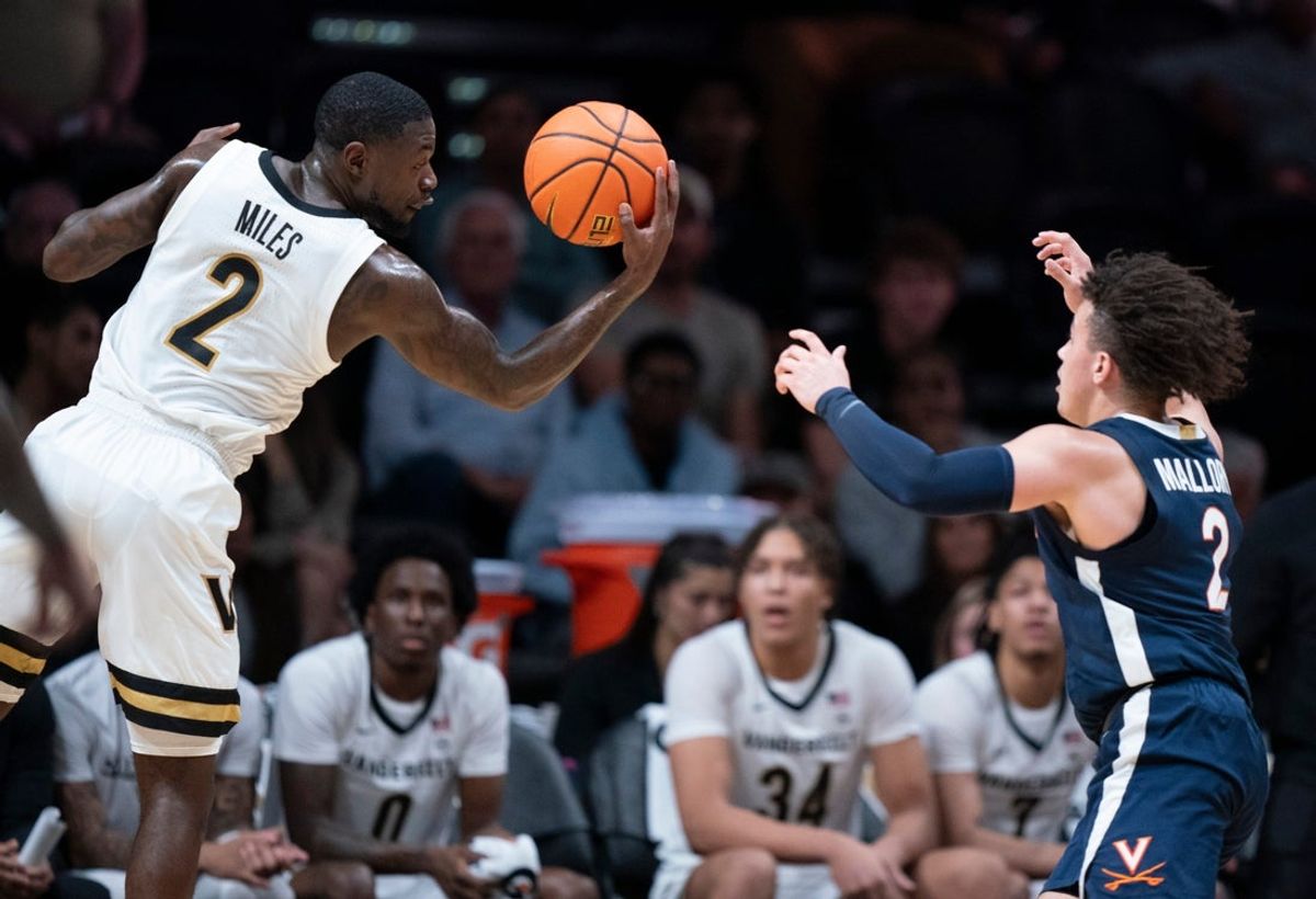Vanderbilt guard Duke Miles (2) pulls in a rebound ahead of Virginia guard Chance Mallory (2) during the first half of their exhibition game at Memorial Gym in Nashville, Tenn., Thursday, Oct. 16, 2025.