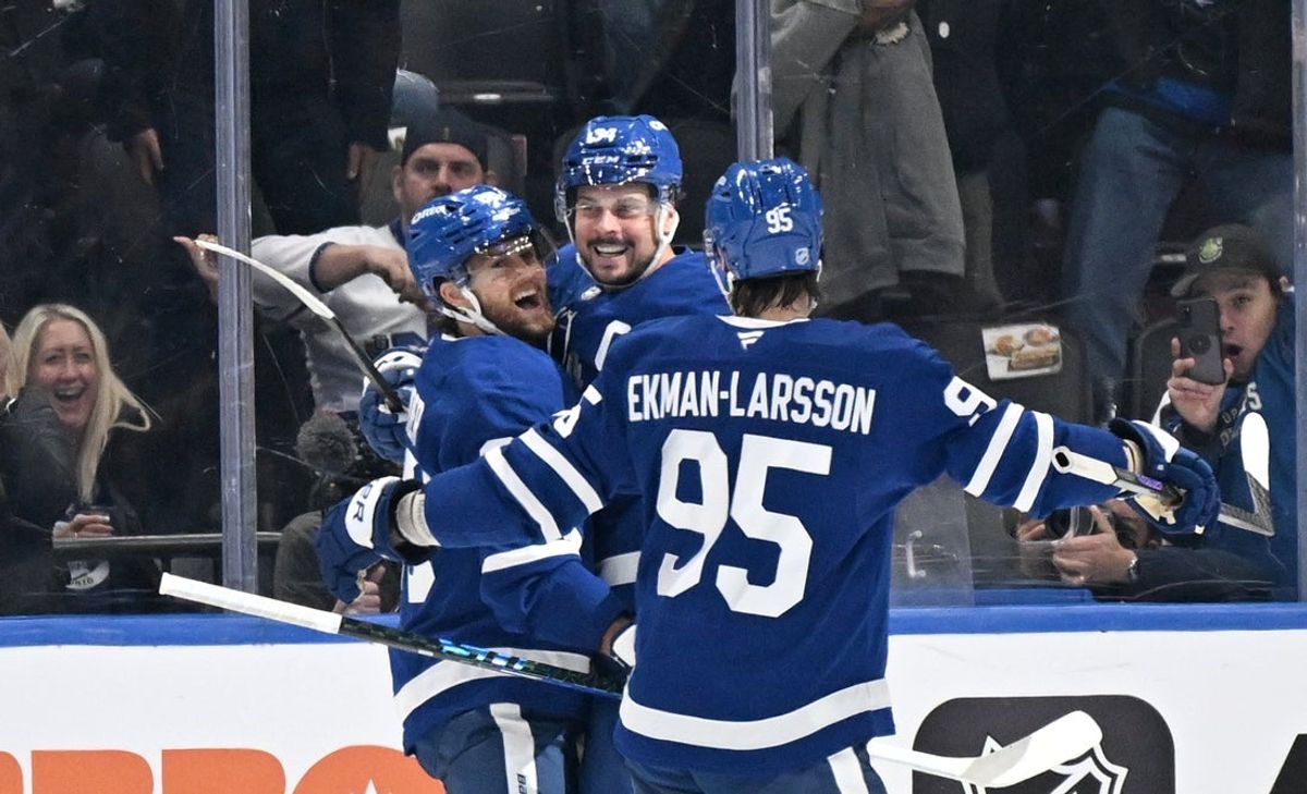 Oct 16, 2025; Toronto, Ontario, CAN; Toronto Maple Leafs forward Auston Matthews (34) celebrates with forward William Nylander (88) and defenseman Oliver Ekman-Larsson (95) after scoring the winning goal against the New York Rangers in overtime at Scotiabank Arena. Mandatory Credit: Dan Hamilton-Imagn Images