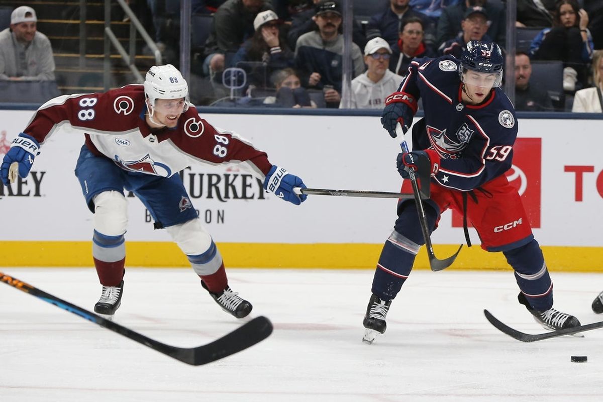 Oct 16, 2025; Columbus, Ohio, USA; Columbus Blue Jackets right wing Yegor Chinakhov (59) passes the puck as Colorado Avalanche center Martin Necas (88) defends during the third period at Nationwide Arena. Mandatory Credit: Russell LaBounty-Imagn Images