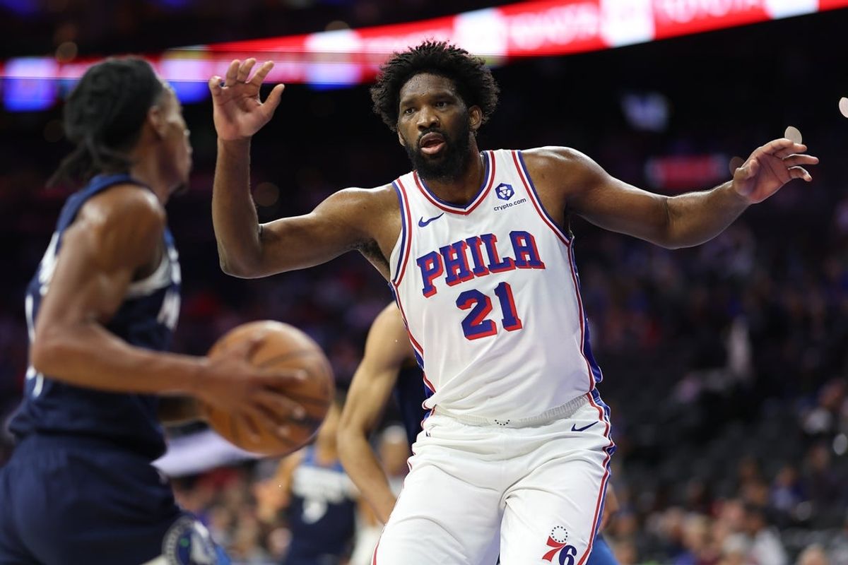 Oct 17, 2025; Philadelphia, Pennsylvania, USA; Philadelphia 76ers center Joel Embiid (21) defends against Minnesota Timberwolves guard Rob Dillingham (4) during the first quarter at Xfinity Mobile Arena. Mandatory Credit: Bill Streicher-Imagn Images