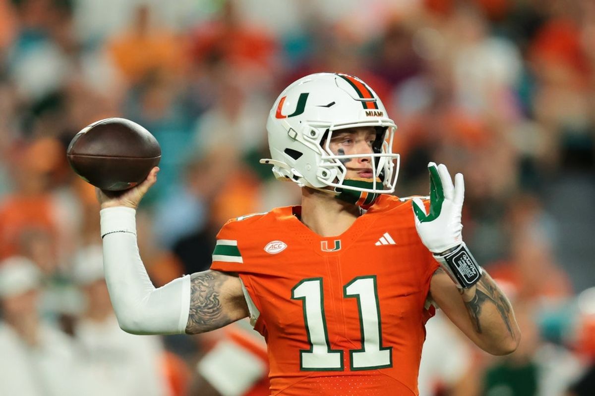 Oct 17, 2025; Miami Gardens, Florida, USA; Miami Hurricanes quarterback Carson Beck (11) throws the football against the Louisville Cardinals during the first quarter at Hard Rock Stadium. Mandatory Credit: Sam Navarro-Imagn Images