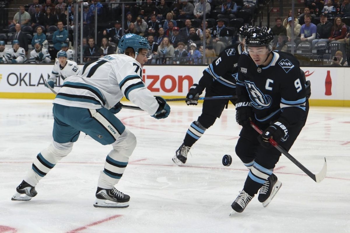 Oct 17, 2025; Salt Lake City, Utah, USA; San Jose Sharks center Macklin Celebrini (71) and Utah Mammoth right wing Clayton Keller (9) play for the puck during the first period at Delta Center. Mandatory Credit: Rob Gray-Imagn Images