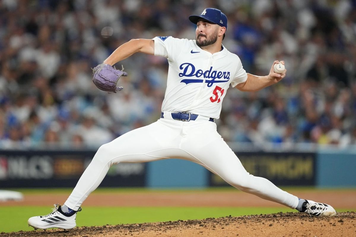 Oct 17, 2025; Los Angeles, California, USA; Los Angeles Dodgers pitcher Alex Vesia (51) pitches against the Milwaukee Brewers in the seventh inning during game four of the NLCS round for the 2025 MLB playoffs at Dodger Stadium. Mandatory Credit: Kirby Lee-Imagn Images