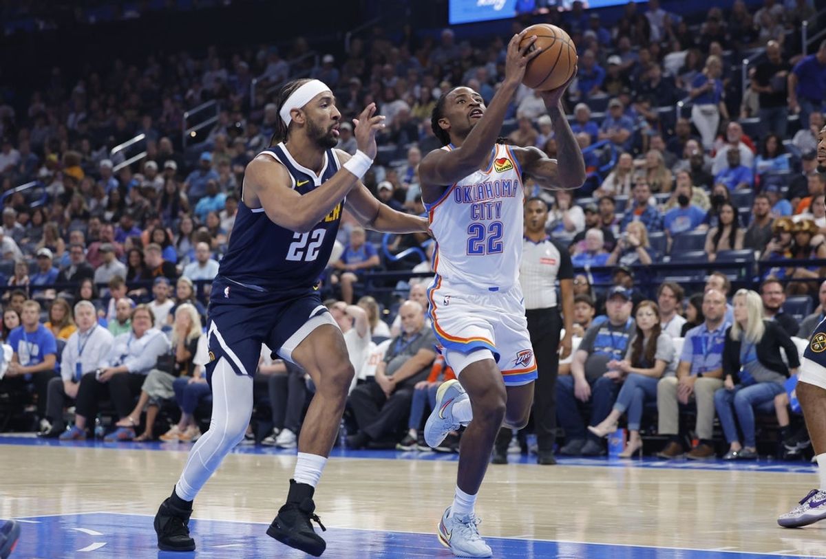 Oct 17, 2025; Oklahoma City, Oklahoma, USA; Oklahoma City Thunder guard Cason Wallace (22) drives to the basket beside Denver Nuggets forward/center Zeke Nnaji (22) during the second half at Paycom Center. Mandatory Credit: Alonzo Adams-Imagn Images